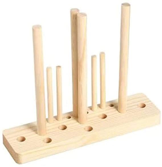 a wooden peg board with six pegs on it