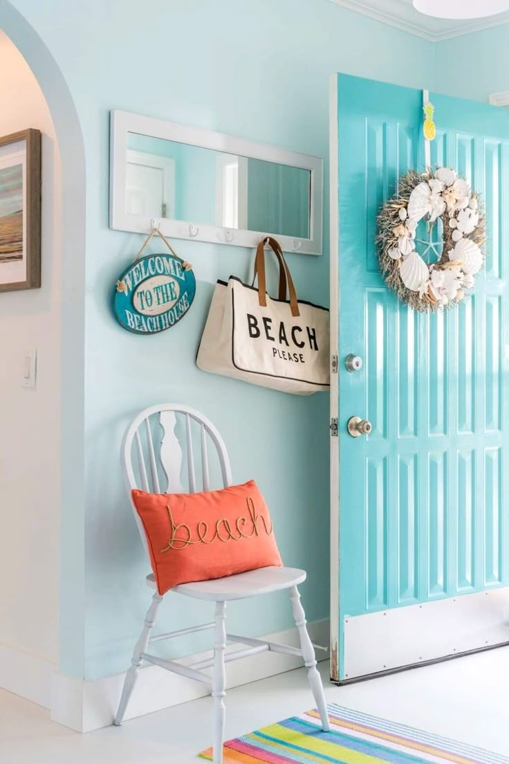 a white chair sitting in front of a blue door