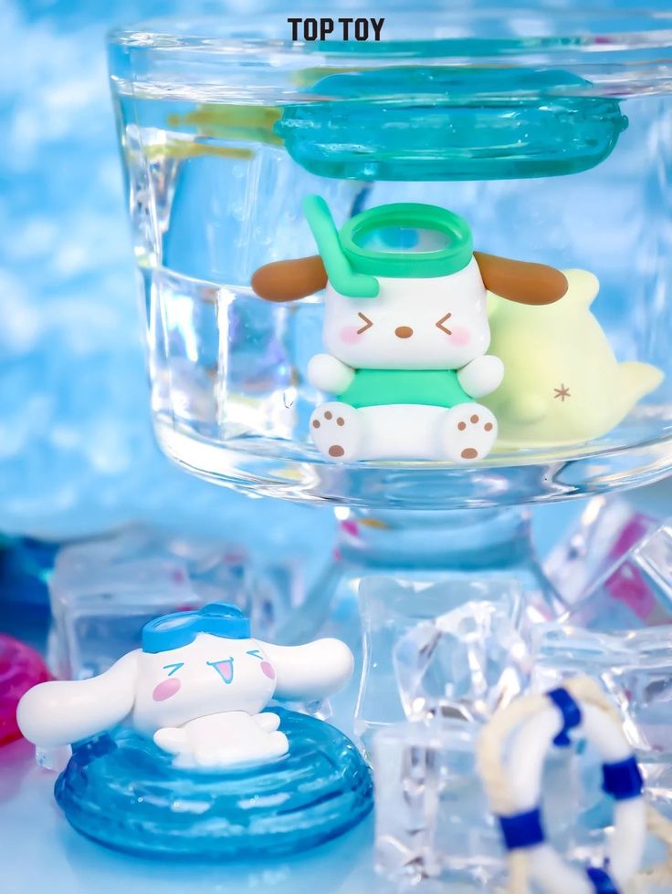 there are many small toys in the glass bowl on top of each other and one is holding a toy