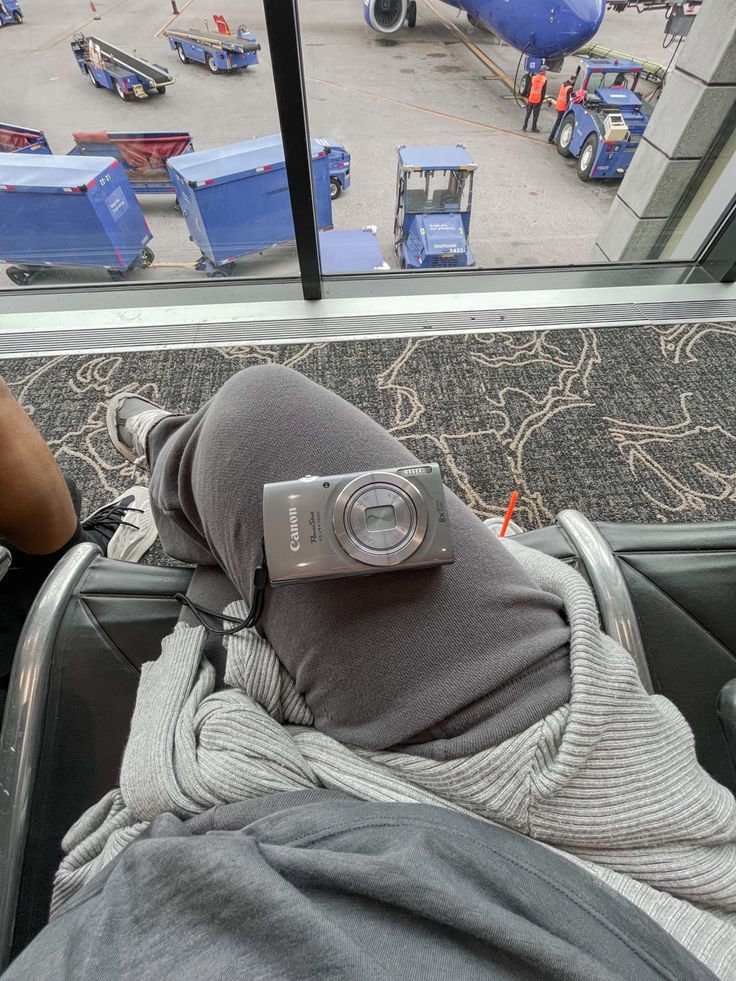 a person with a camera on their head sitting in an airport