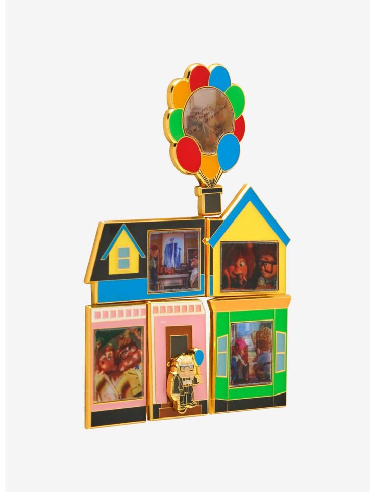 a multicolored house with balloons on top