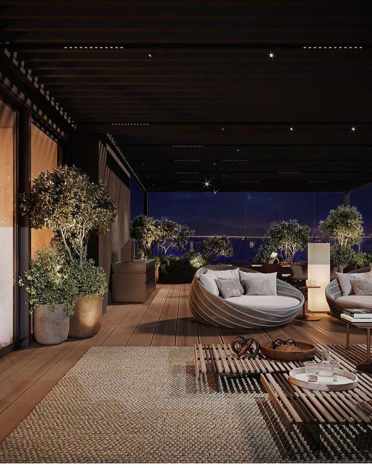 a living room filled with furniture and potted plants on top of a hard wood floor