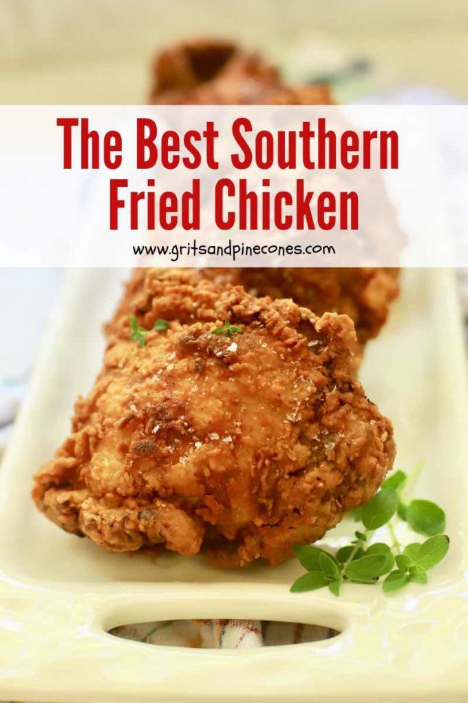 the best southern fried chicken recipe on a white plate with parsley sprigs