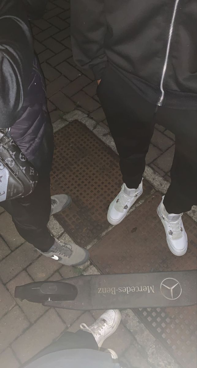 two people standing next to each other with white shoes