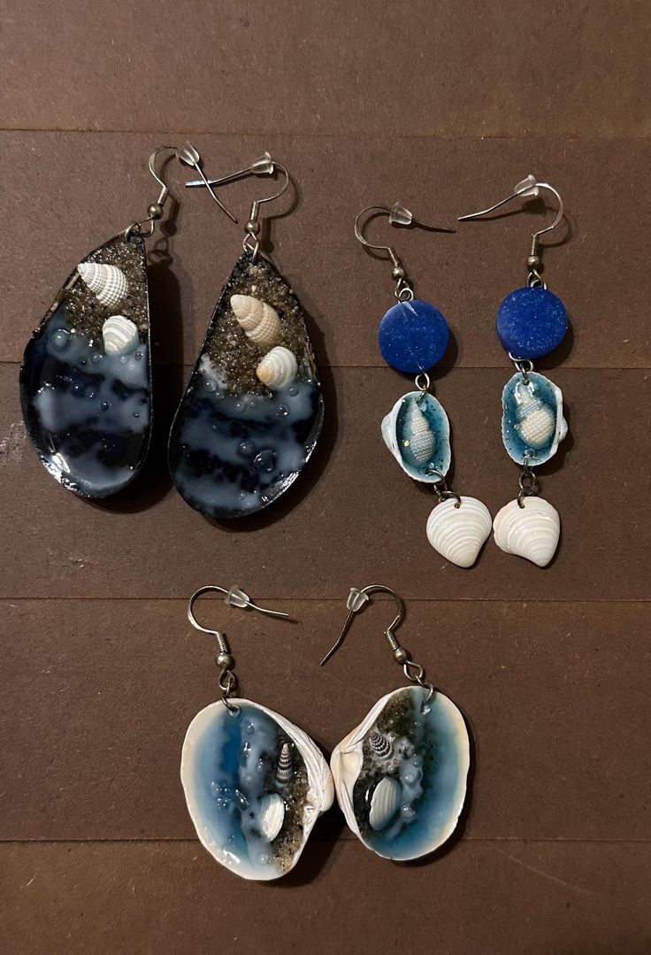 Seashells used are from my local beach. They are taken home, washed, and with resin and a little magic and love, tiny beaches are made! Earring type will be chosen and sent by random! White Resin Earrings For The Beach, Handmade Ocean-inspired Earrings For Beach, Handmade Ocean-inspired Earrings For Beach Season, Ocean-inspired Shell Earrings As Gift, Beach Season Shell Earrings Gift, Beach Season Gift Shell Earrings, Shell Earrings For Beach Season Gift, Shell-shaped Earrings For Beach Season Gift, Blue Resin Earrings For Beach