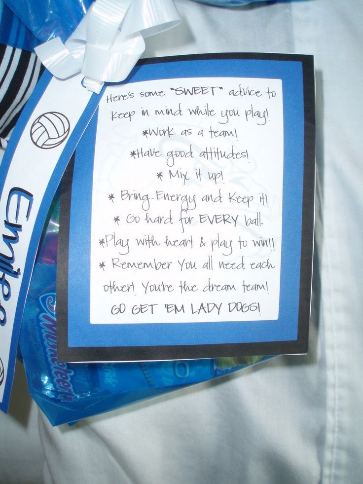 a person wearing a white shirt and holding a blue bag with an award on it