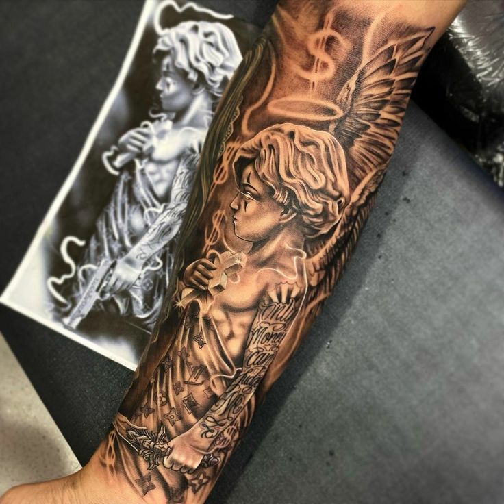 a man's arm with an angel and cherub tattoo on the left forearm