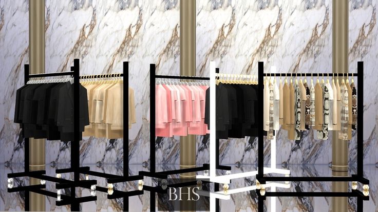 three racks with clothes hanging on them in front of a marble wall