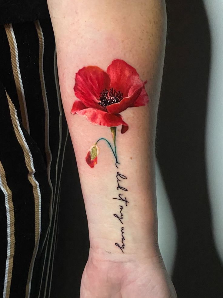 a woman's arm with a red flower and the words happy birthday written on it