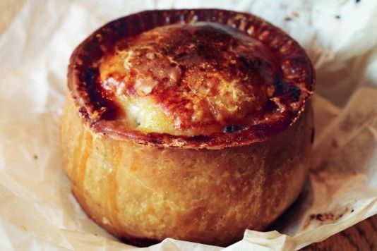 a baked pastry sitting on top of wax paper