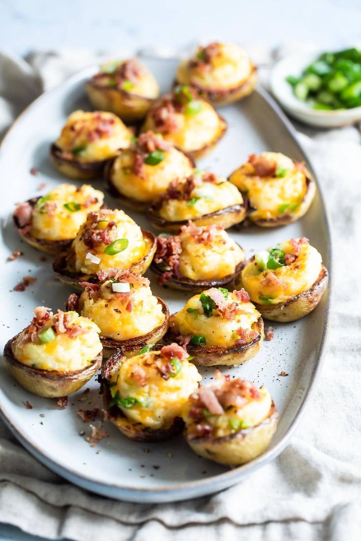 small appetizers are arranged on a white platter, ready to be eaten