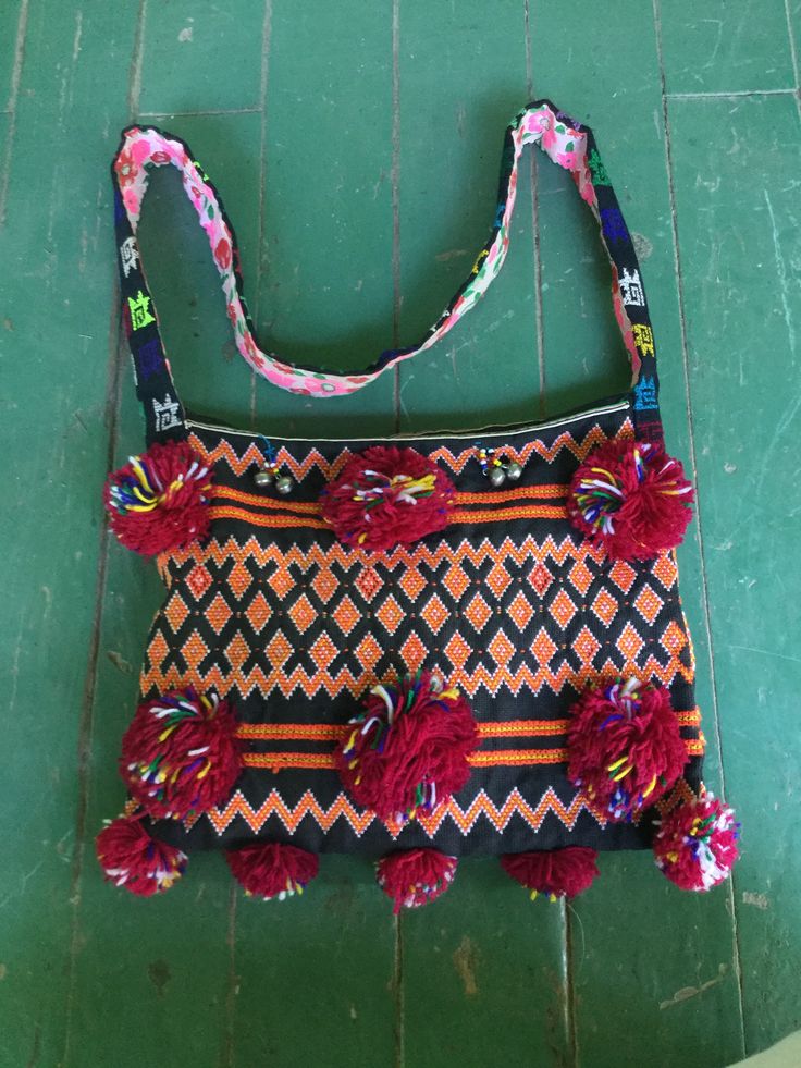 "A wonderful handmade folk art tribal bag Fashioned of handwoven cotton fabric with geometric patterns, decorated with pom poms and little ringing bells! Has a great tribal, bohemian hippie vibe Handmade in India? South America? Lined with colorful floral cotton fabric Zipper closure keeps all your valuables inside Shoulder strap for easy carry Hold books, a small lap top, all your important smalls Great for around campus, or festival wear! Dimensions 12\"x 9\" expands to about 6\" wide Shoulder Lap Top, Yarn Pom Pom, Hippie Vibes, Bohemian Hippie, Edwardian Era, Hippie Bohemian, Geometric Patterns, Pom Poms, Festival Wear