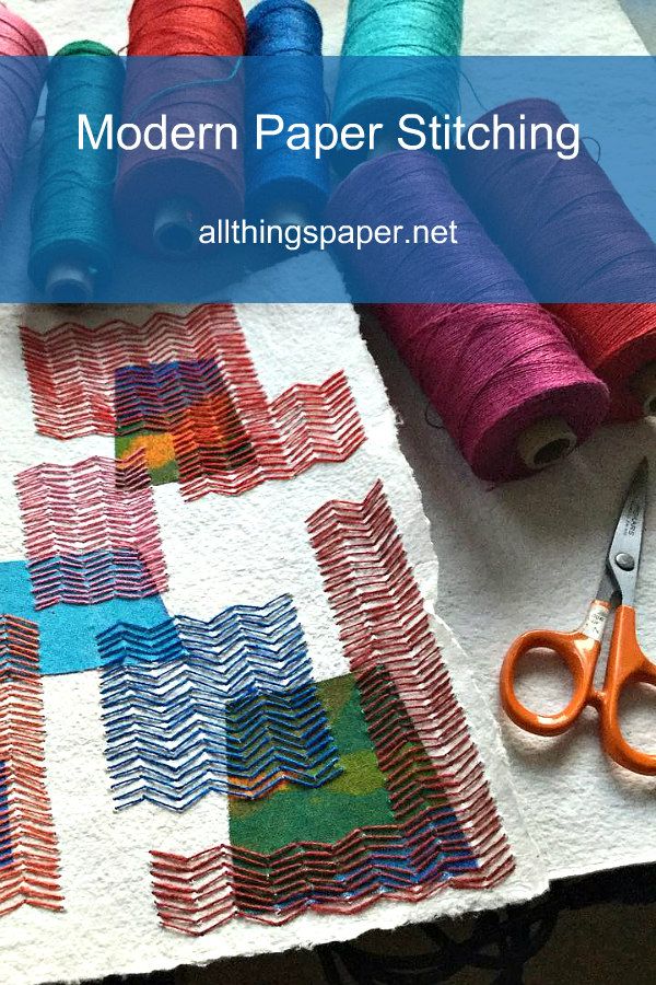 several spools of thread sitting on top of a table next to some scissors