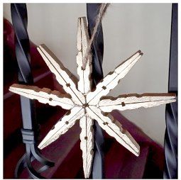 a wooden snowflake sitting on top of a table next to a red chair