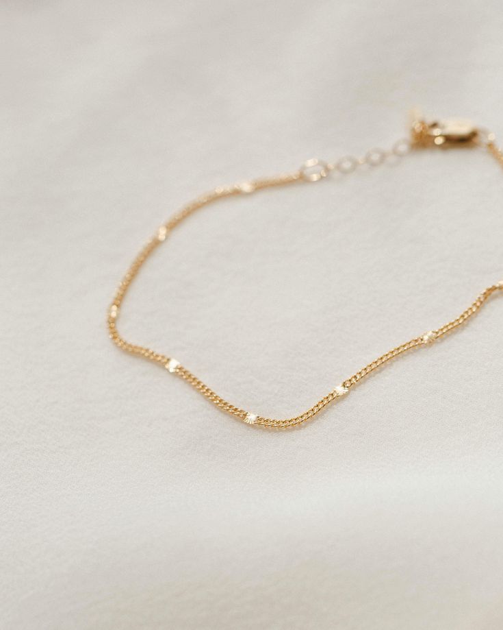 The bracelet that shines like summer incarnate. Each chain is dotted with little sunbursts to catch the light—like fireflies, twinkling lights and golden hour all rolled into one! Style it solo, stack with your favorite bracelets or add a charm for an extra sparkle of personalization. Want to shine even brighter? Check out the full Radiant Collection. Dainty 14k Gold Bracelet With Extender, Everyday Gold Bracelet With Satellite Chain, Dainty Adjustable Yellow Gold Chain Bracelet, Adjustable Delicate Gold Bracelet With Chain, Adjustable Dainty Yellow Gold Chain Bracelet, Delicate Gold Bracelet With Satellite Chain For Everyday, Delicate 14k Gold Filled Jubilee Bracelet, Dainty Gold Bracelet With Extender, Dainty 14k Gold Filled Jubilee Bracelet