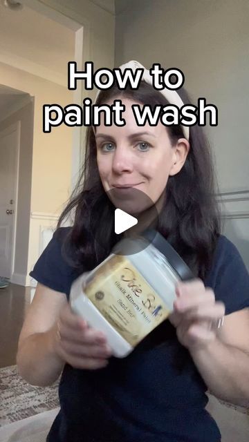 a woman holding a can of paint in front of her face with the words how to paint wash on it