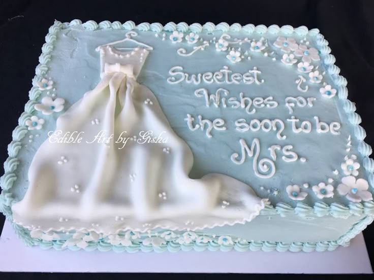 a wedding cake that is decorated with white frosting and blue icing on it