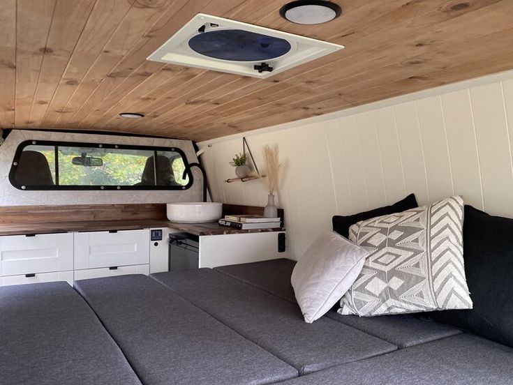 the interior of a camper with wood ceiling