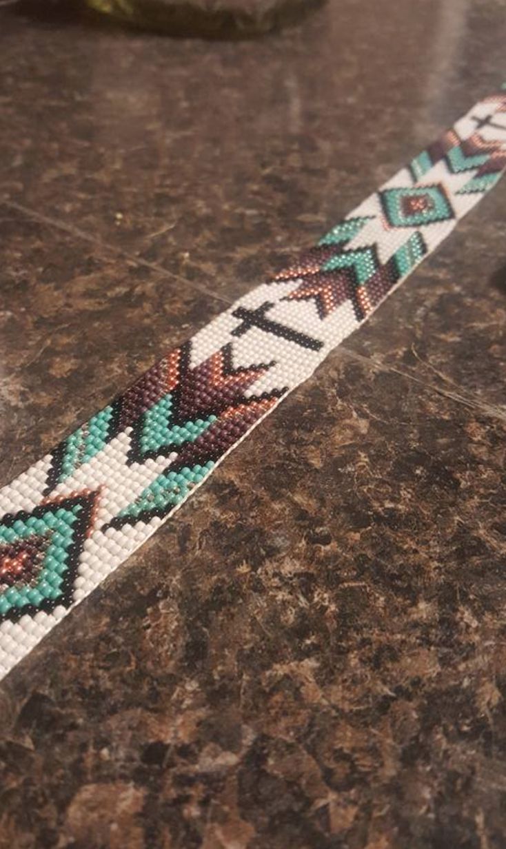 a beaded bracelet sitting on top of a table