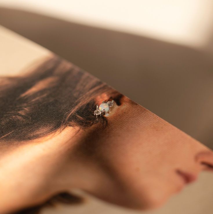 a woman's face is shown through the pages of a book with her eyes closed