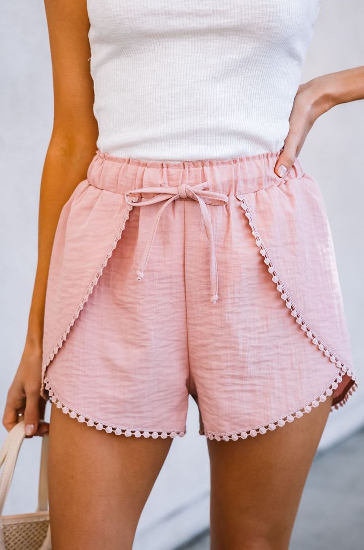 Description Add a fun and playful touch to your summer wardrobe with our Tulip Tie Waist Pom Shorts. Made from high-quality material, these shorts are both comfortable and stylish, perfect for any occasion. The tie waist and tulip hem create a flattering silhouette that's both feminine and chic, while the pom trim adds a playful touch. These versatile shorts can be dressed up with a blouse and heels for a night out, or dressed down with a t-shirt and sneakers for a casual look. The bright and co Trendy Summer Shorts With Pockets, Casual Bermuda Bottoms For Summer Outings, Summer Beach Shorts With Pockets, Trendy Summer Bottoms With Elastic Waistband, Casual Beach Shorts For Spring, Casual Short Bottoms For Summer, Beachwear Bottoms With Built-in Shorts For Day Out, Summer Drawstring Knee-length Shorts, Summer Shorts With Elastic Waistband For Day Out