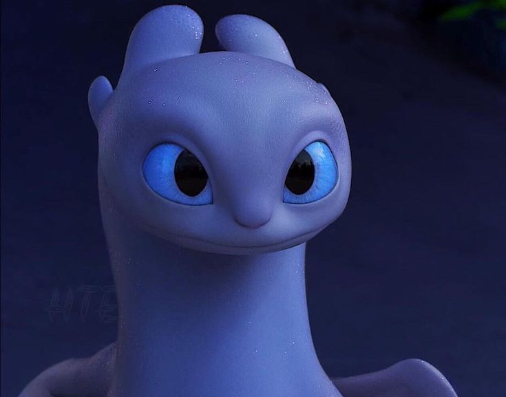 a close up of a toy dragon with blue eyes