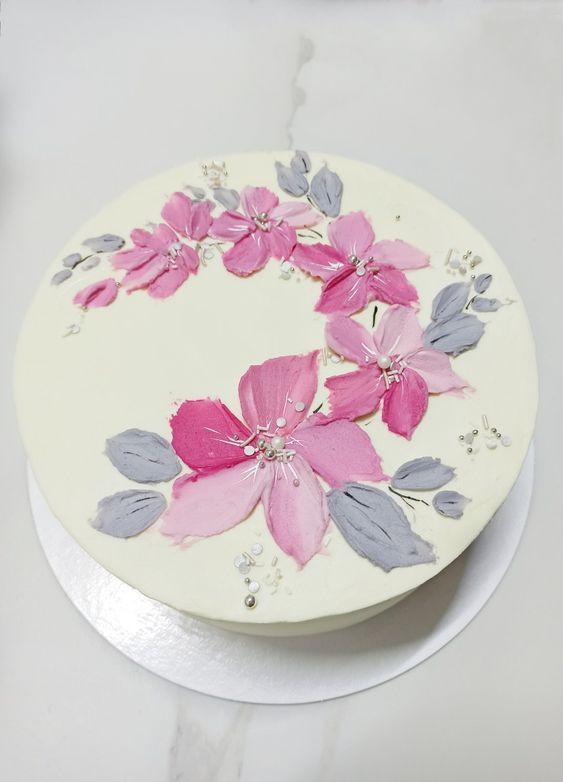 a white cake with pink flowers on it