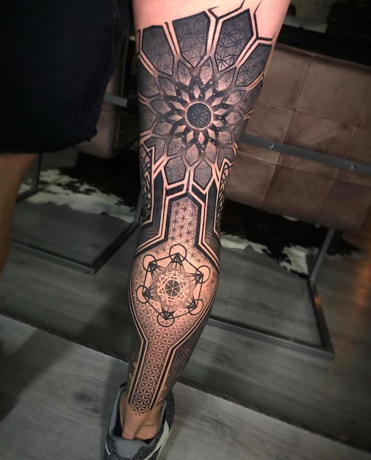 a woman's leg with an intricate tattoo design on the calf and lower leg