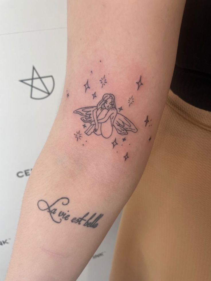 a woman's arm with a small tattoo on it