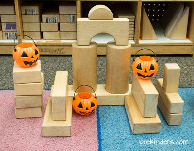 wooden blocks with carved pumpkins on them sitting in front of a store display case