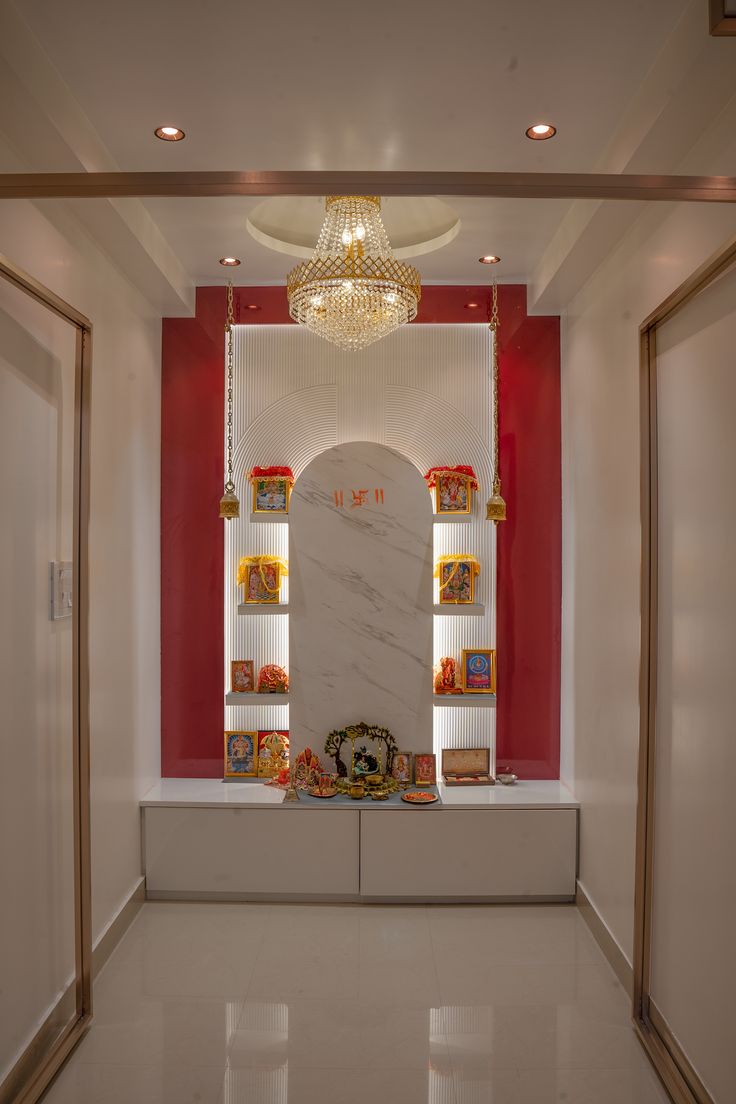 the room is decorated in white and red with gold accents on the walls, along with a marble shelf