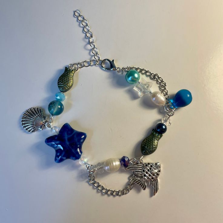 A handmade metkayina ocean themed charm bracelet! So cute and perfect for summer! Beach Charms Bracelet Jewelry, Adjustable Chain Bracelet For Beach, Ocean-inspired Bracelet With Starfish Charm, Beach Jewelry With Charms In Ocean-inspired Style, Bohemian Style Bracelet With Starfish Charm, Ocean-inspired Jewelry With Charms For Beach, Ocean-inspired Starfish Charm Bracelet, Ocean-inspired Starfish Charms Jewelry, Ocean-inspired Beach Jewelry With Charms