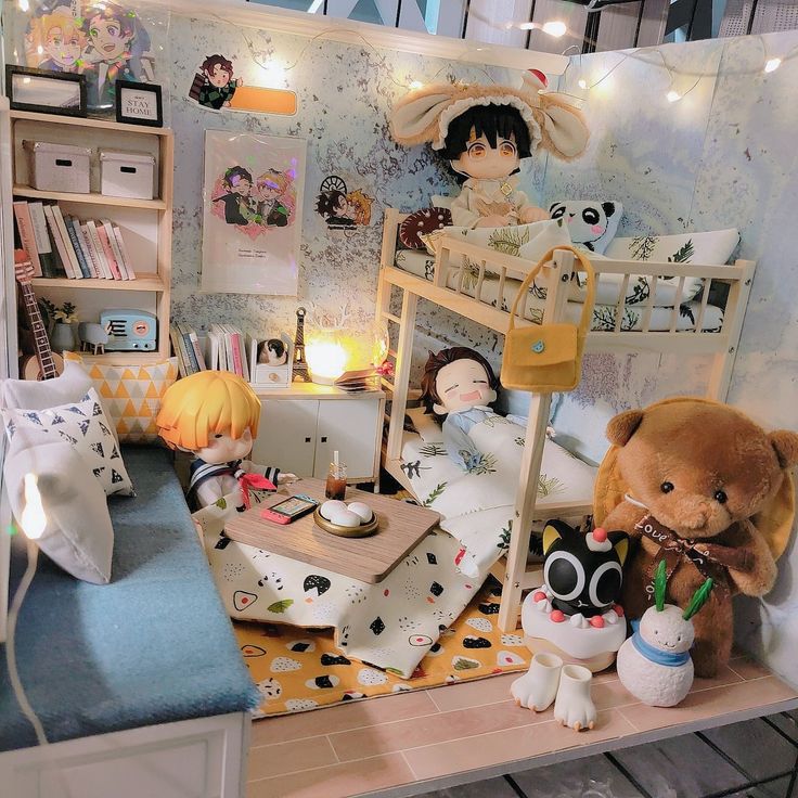 a doll house with stuffed animals and dolls on the bed in it's room