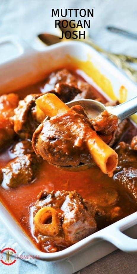 a close up of a spoon in a dish of food with text overlay that reads mutton rogan josh