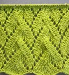 a green knitted piece with holes in the center and two rows of stitches on each side