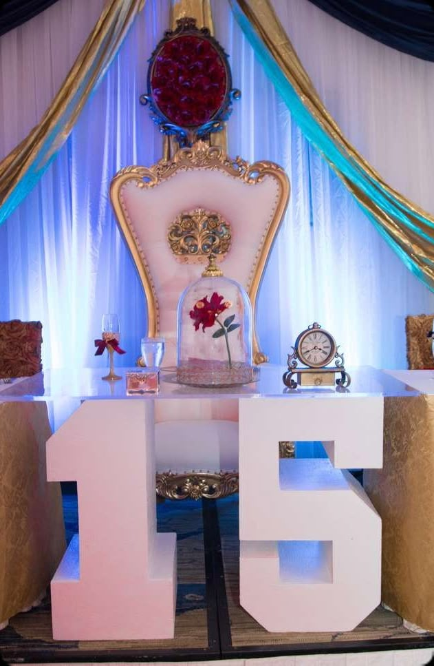 an elaborately decorated chair and table with the number fifteen on it's side