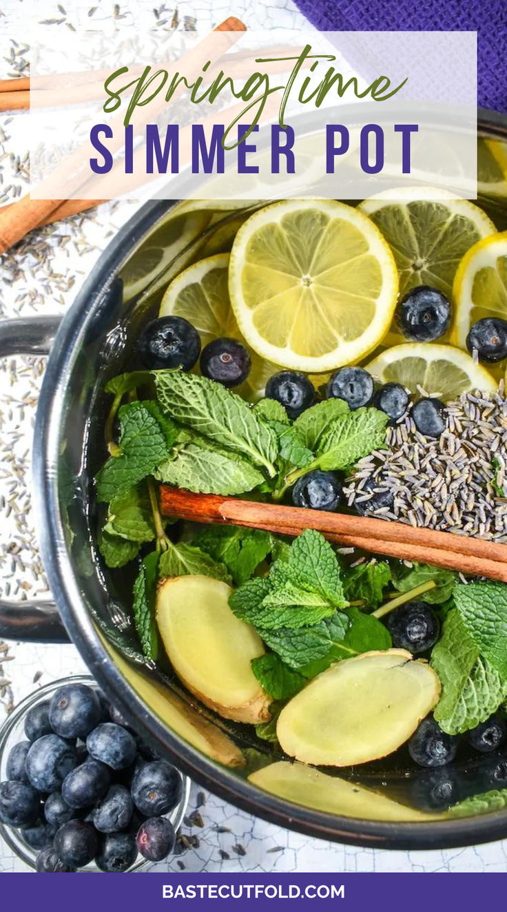 a pot filled with blueberries, lemons and herbs