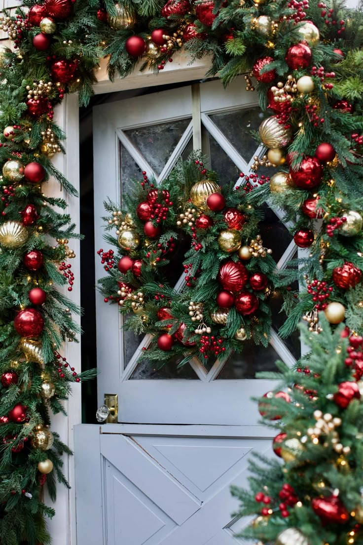 christmas wreaths and ornaments are hanging on the front door to create a festive display