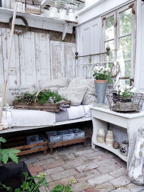 an outdoor room with lots of potted plants on the windowsill and furniture in it