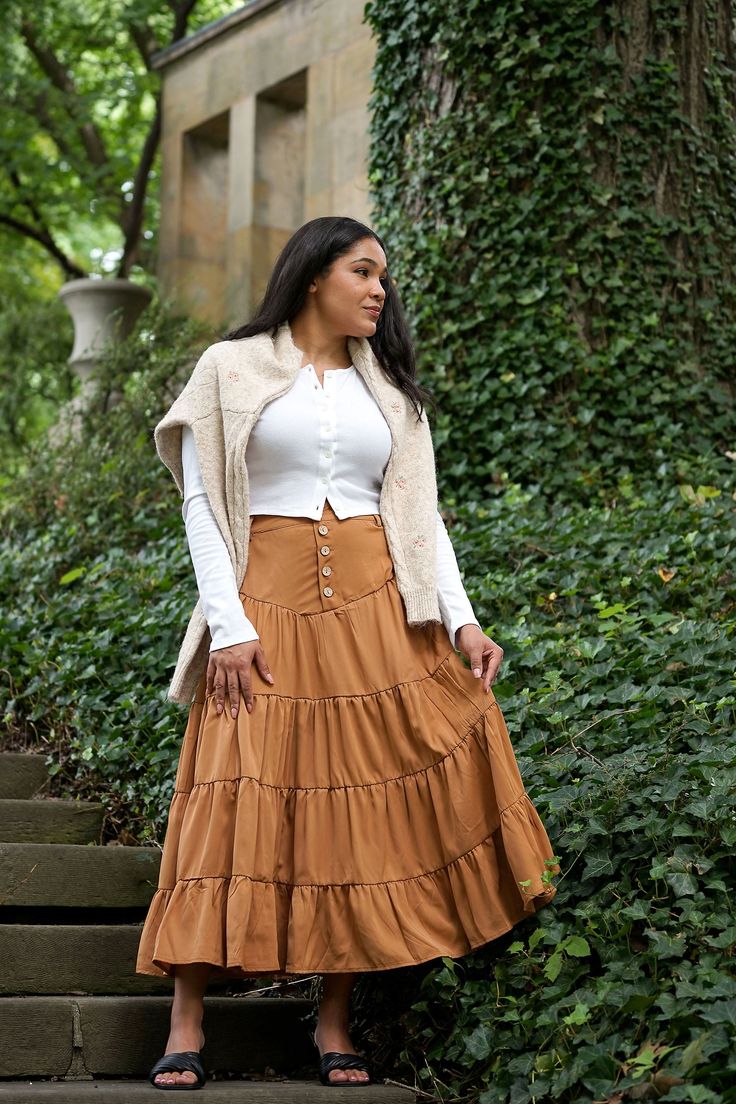 Romantic cottage core inspired vintage maxi tired skirt, the Pumpkin skirt was inspired by past vintage style with a back elastic band along with a five button closure front and belt loops. The Pumpkin skirt features a half slip. 100% Polyester / Half Lined Hand Wash Cold / Line Dry Hidden Side Pockets Fit Notes & Measurements Rosa is 5’6 and wearing a size small XS: 27" length / 25"-27" waist / max 34" hips S: 27.5" length / 27"-29" waist / max 36" hips M: 28" length / 29"-31" waist / max 38" h Fall Wide Leg Skirt With Buttons, Bohemian Daywear Maxi Skirt With Lining, Bohemian Daywear Lined Maxi Skirt, Fitted Bohemian Maxi Skirt For Daywear, Fall Tiered Maxi Skirt, Bohemian Ruffled Skirt Bottoms For Fall, Long Skirt With Button Closure For Fall, Bohemian Gathered Skirt For Fall, Bohemian Tiered Skirt For Fall