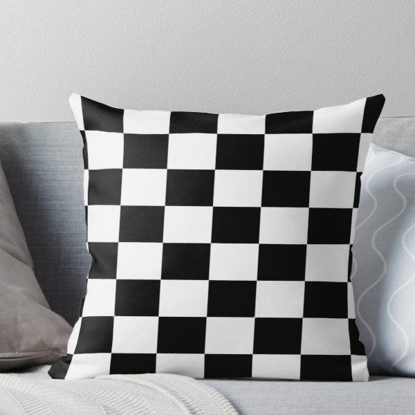 a black and white checkered pillow on a couch