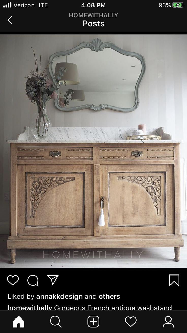 a large wooden cabinet with a mirror above it