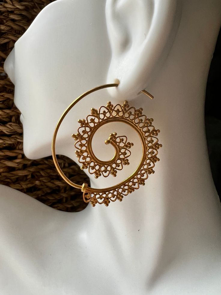 We think these unique handcrafted beauties are just exquisite. We love the attention to detail of the artisans making this fine filigree work. This intricate spiral of an earring is an attention grabber and sure to become an instant favorite. Artisans that do this type of work are becoming increasingly rare, and we want to support their efforts as much as possible. How could we not when something like this is the outcome? If you like filigree, you may also want to consider: intricate delicate fi Elegant Filigree Hoop Earrings, Spiral Jewelry With Intricate Design For Gift, Handmade Bohemian Swirl Earrings, Traditional Handmade Spiral Jewelry, Traditional Filigree Hoop Earrings, Ornate Gold Filigree Hoop Earrings, Bohemian Gold Swirl Jewelry, Traditional Spiral Metal Jewelry, Ornate Gold Filigree Earrings