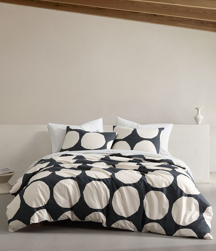 a bed with black and white polka dots on it