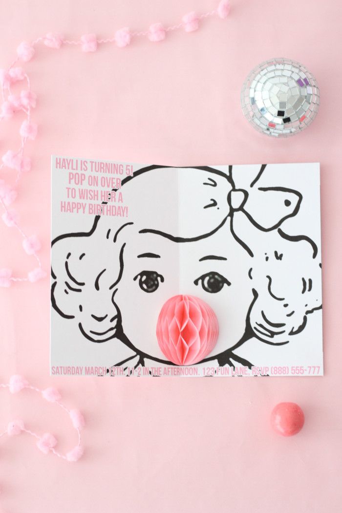 a paper cut out of a woman's face on top of a pink background