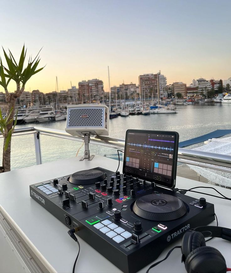 a dj's turntable sitting on top of a table next to a laptop