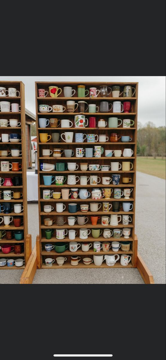 two wooden shelves filled with cups and saucers on top of each other in front of a parking lot