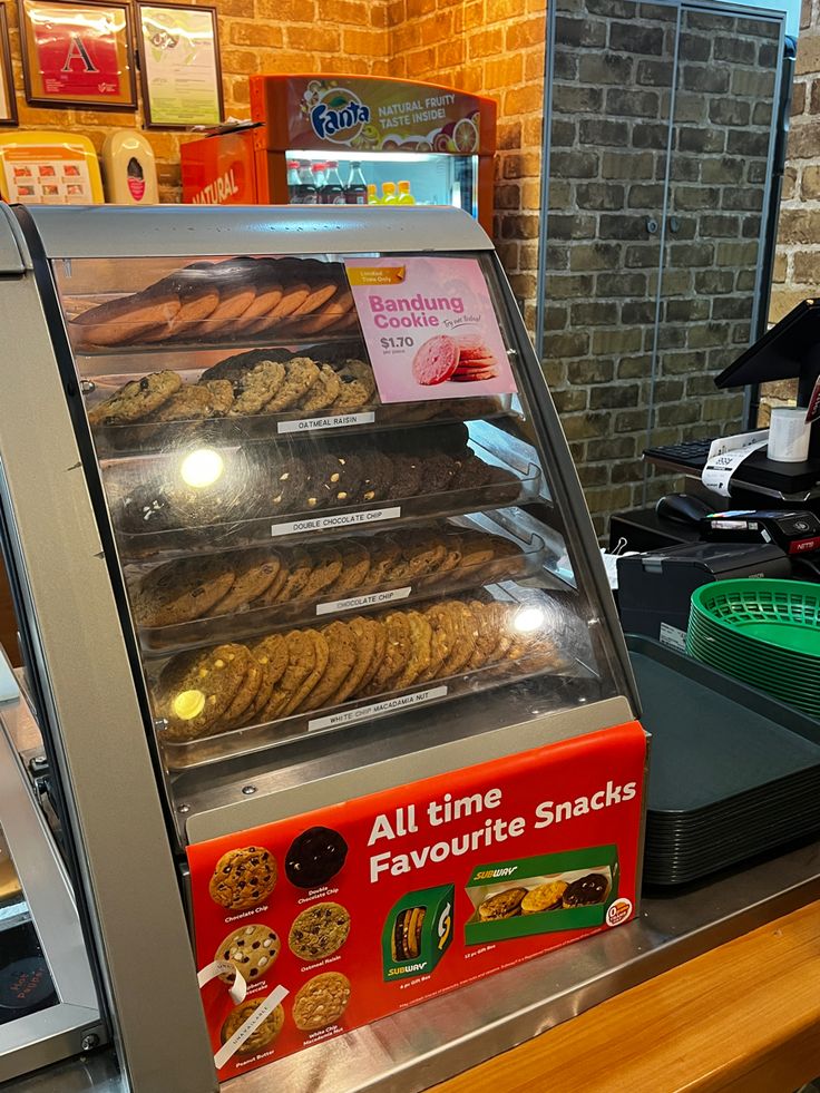 a display case filled with lots of different types of cookies on top of a counter