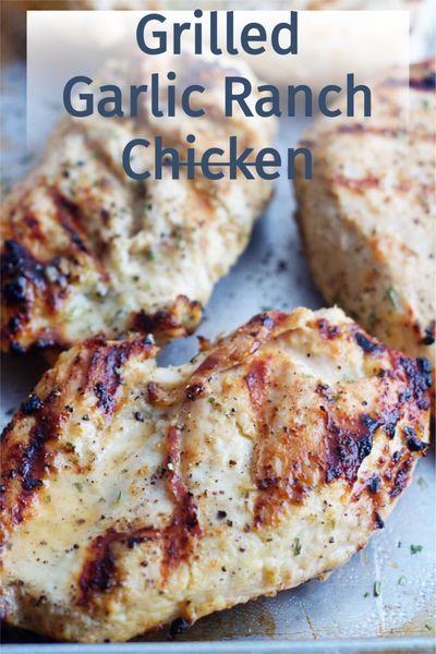 grilled garlic ranch chicken on a baking sheet with text overlay that reads grilled garlic ranch chicken