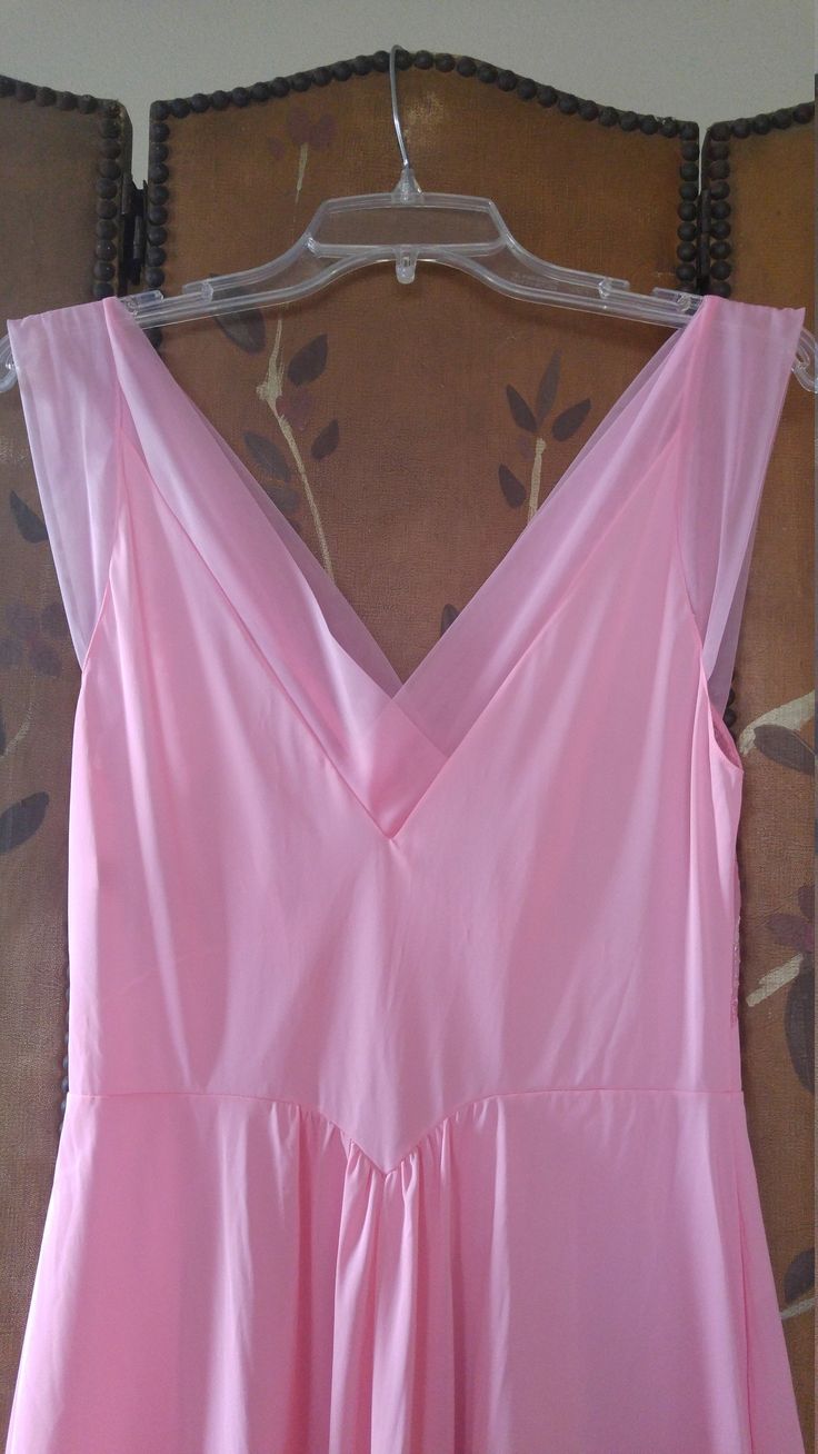 "70s gorgeous bubblegum pink nylon maxi slip / nightie by Vanity fair. The bust has delicate embroidered flower detail. Waist is accentuated with a deep V and a maxi length skirt part. Sheer hem and shoulder straps. **just very light 'scratch' marks on bottom of skirt but barely visible** Size 36 Nylon Length 55\", waist 28\" Made by vanity fair" V-neck Maxi Dress For Wedding Night In Spring, Summer Pink Maxi Dress With Lined Bodice, Pink Maxi Dress With Lined Bodice For Summer, Pink Maxi Dress With Sheer Bodice, Pink Lined Bodice Maxi Dress For Summer, Spring Pink Dress With Sheer Bodice, Pink Spaghetti Strap Dress For Wedding Night, Pink Sheer Maxi Dress For Summer, Sleeveless Pink Maxi Dress With Lined Bodice